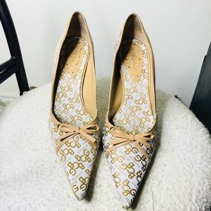 BCBGirls logo tan and white heels.